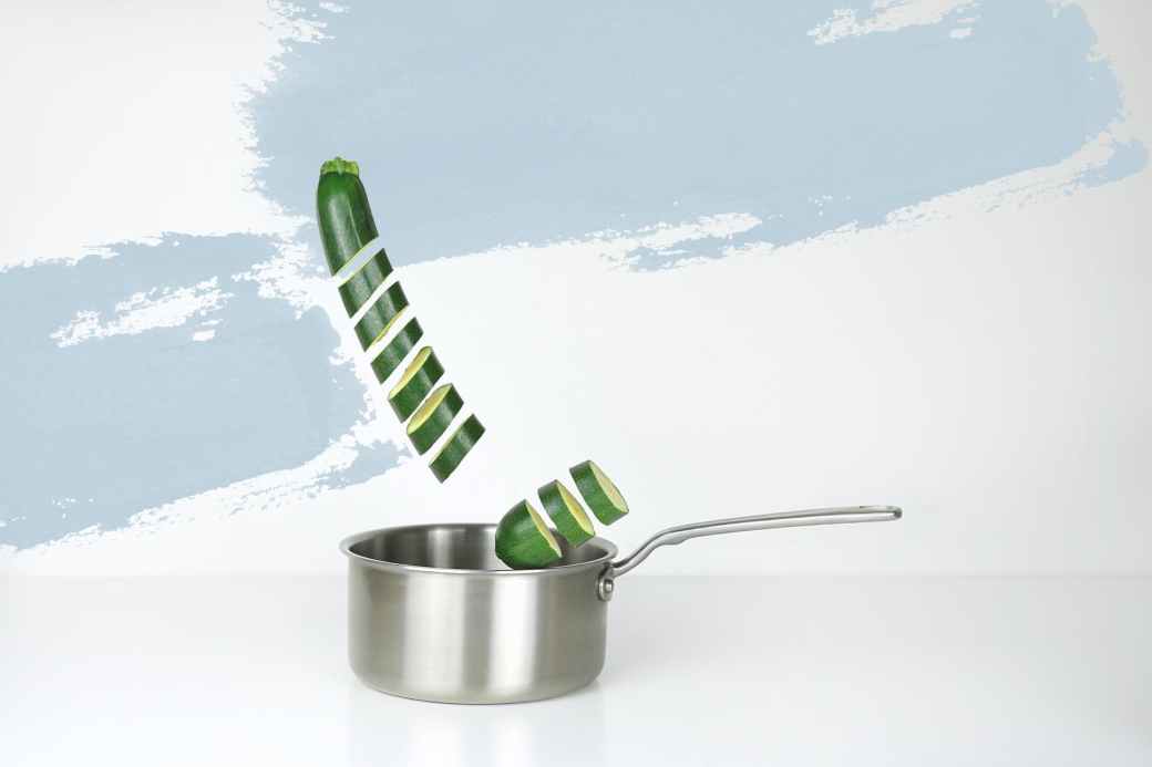 gray stainless steel sauce pan and green cucumber illustration