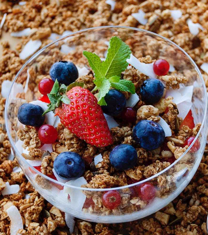 strawberry and blueberry on clear glass bowl