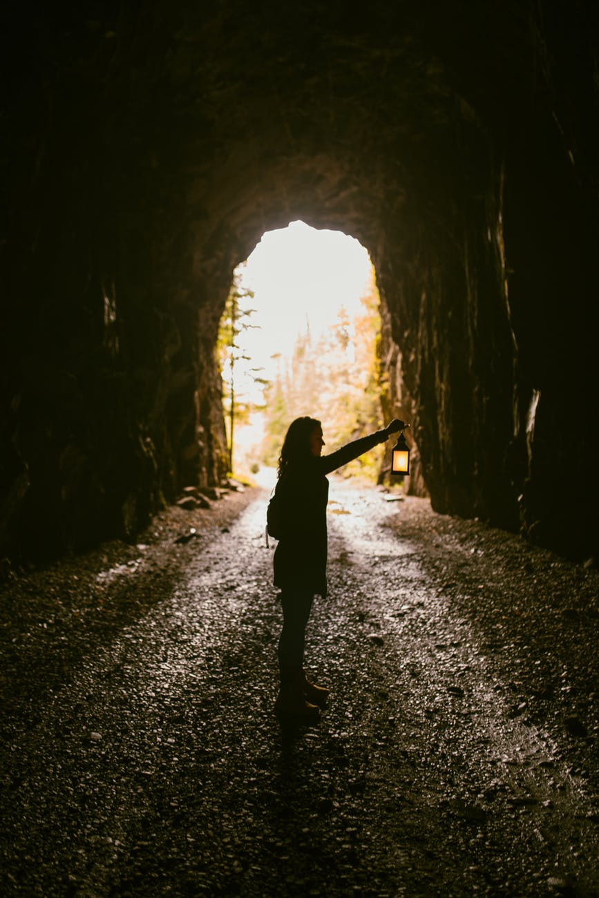 woman standing inside cave